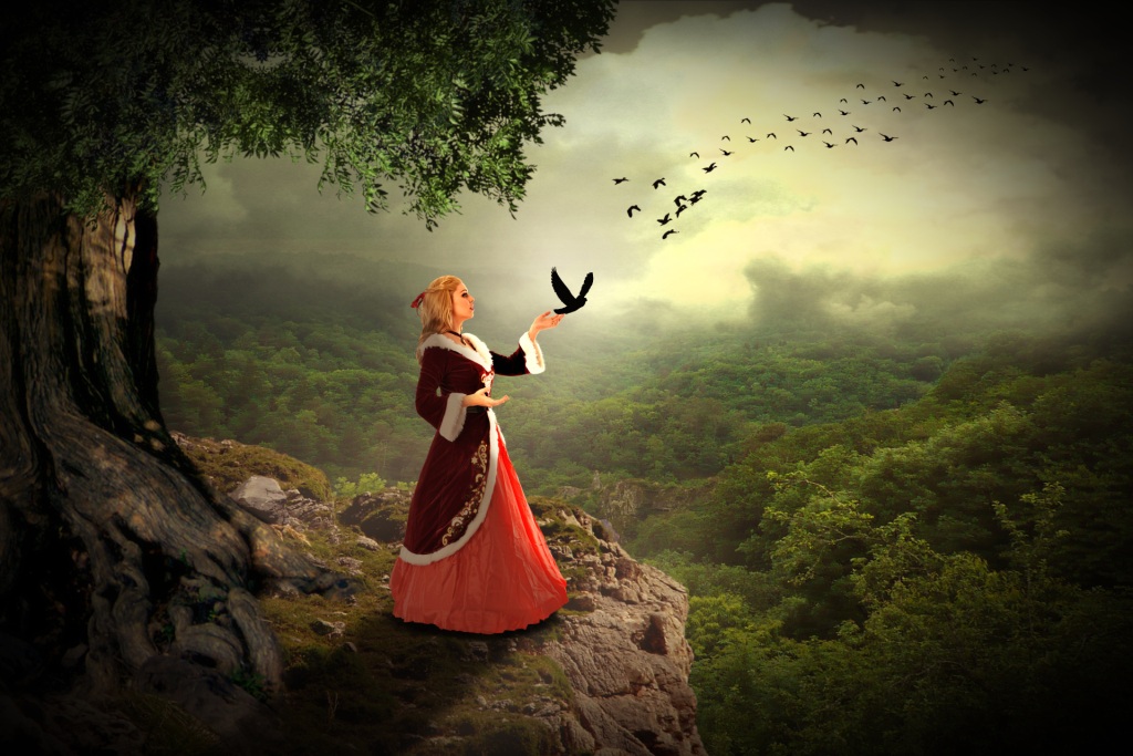 Fantasy woman on cliff releasing many birds