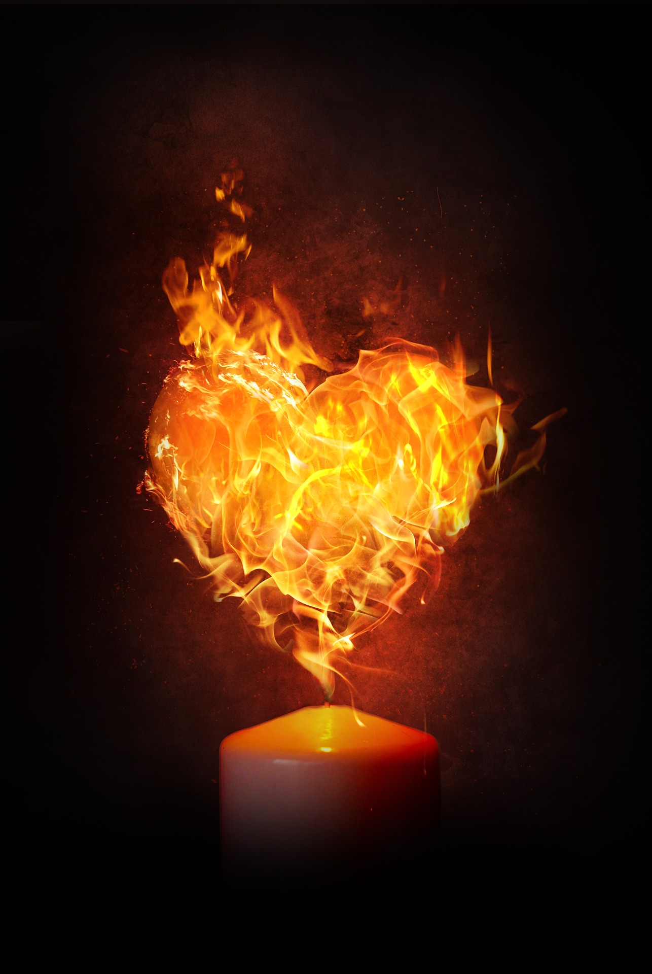 Against a dark background, the tip of a thick candle is lit. A large heart of fire is behind the candle flame, far larger than the flame.