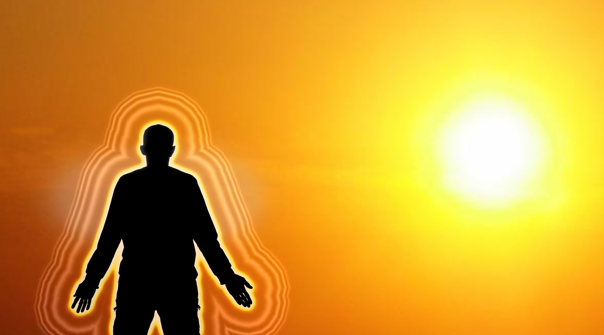 The silhouette of a standing man looking at a giant rising sun. Concentric auric emanations surround his silhouette. He is spiritualising his aura with solar energies.