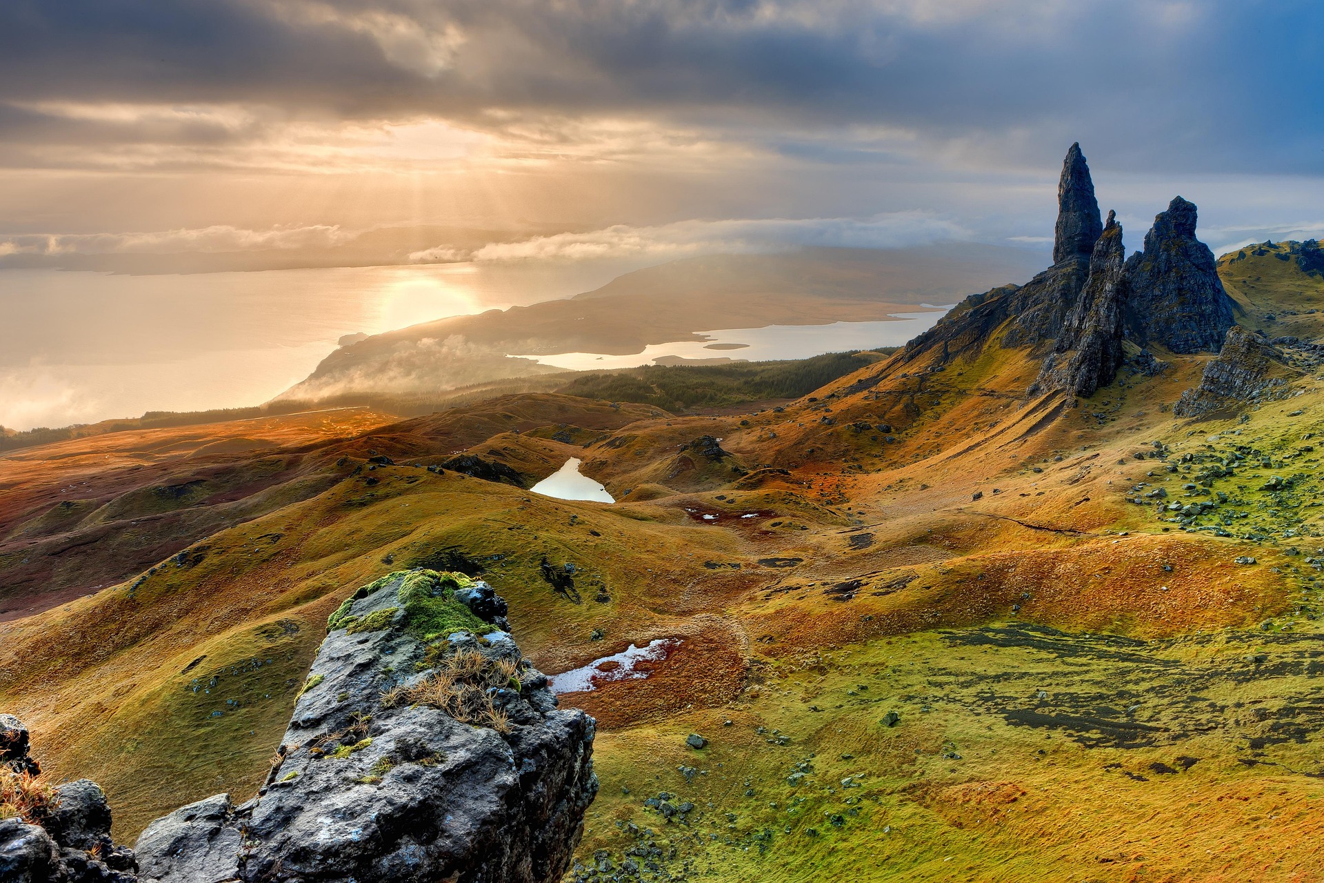 A mountain landscape and a powerful sun is above the horizon