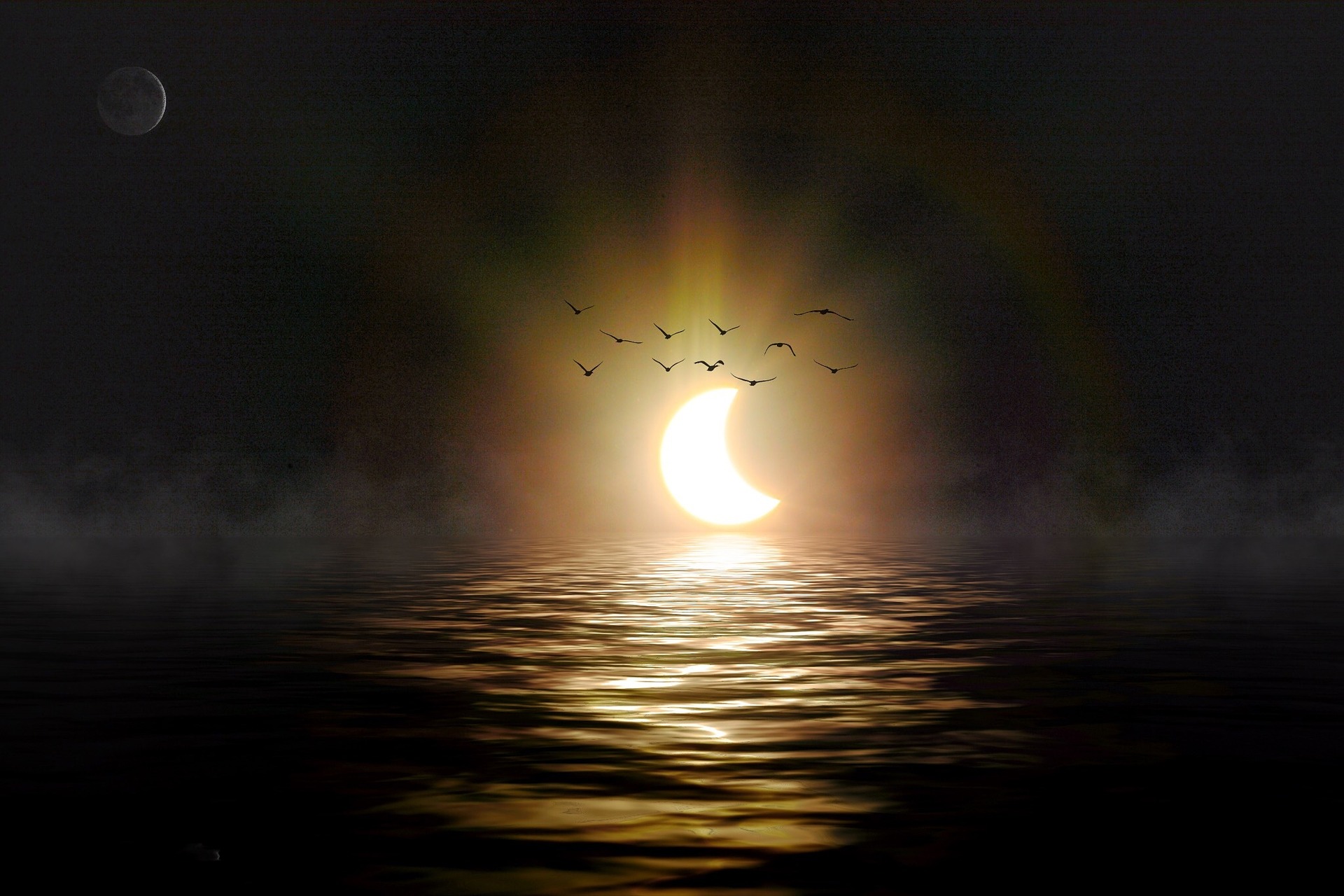 A recently eclipsed  sun is reappearing on the horizon of a lake or the sea. The moon is visible at top left. Birds fly towards us as if from the sun.