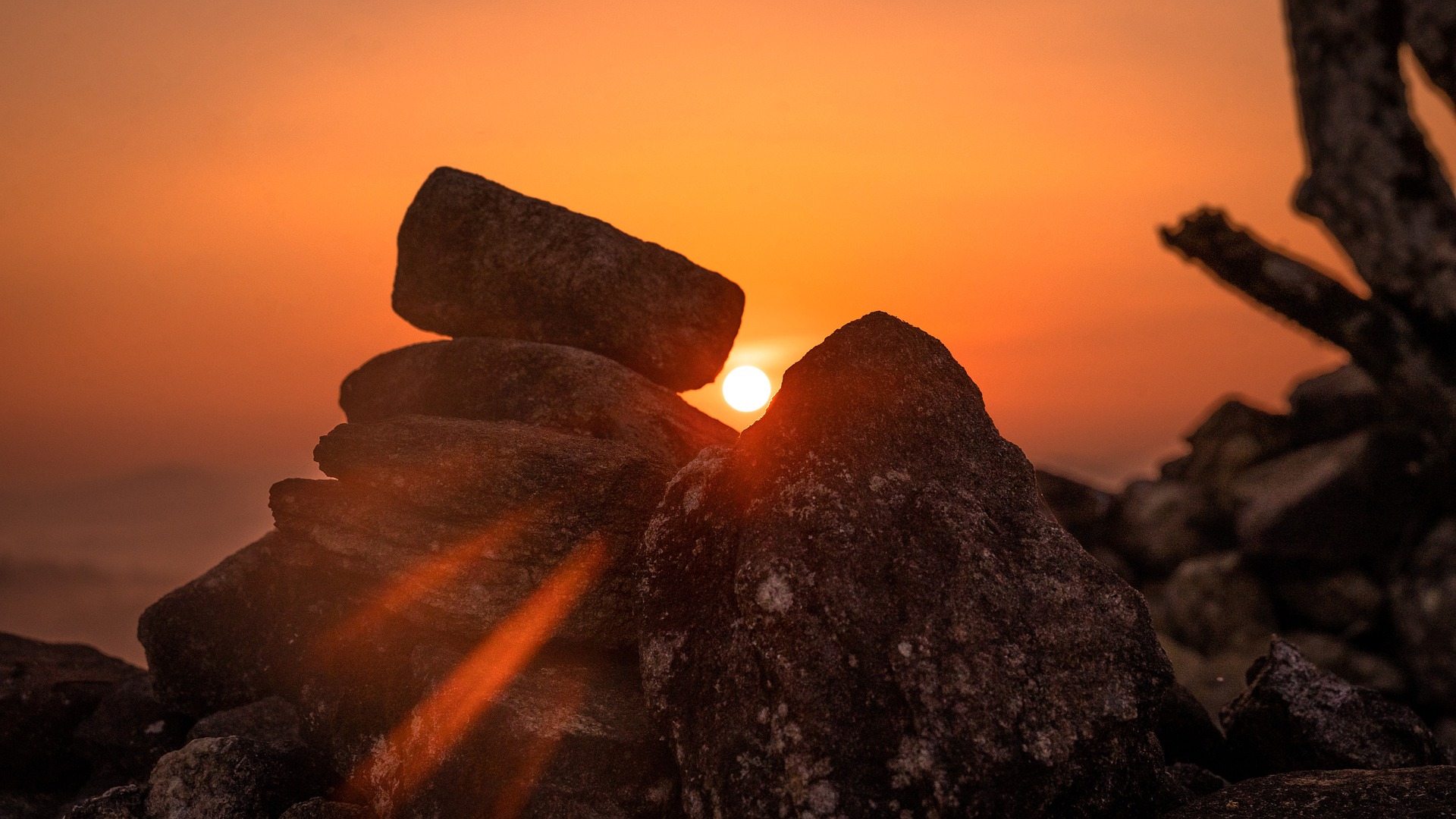 Through a pile of stacked, ancient stones, we see the sun rising!
