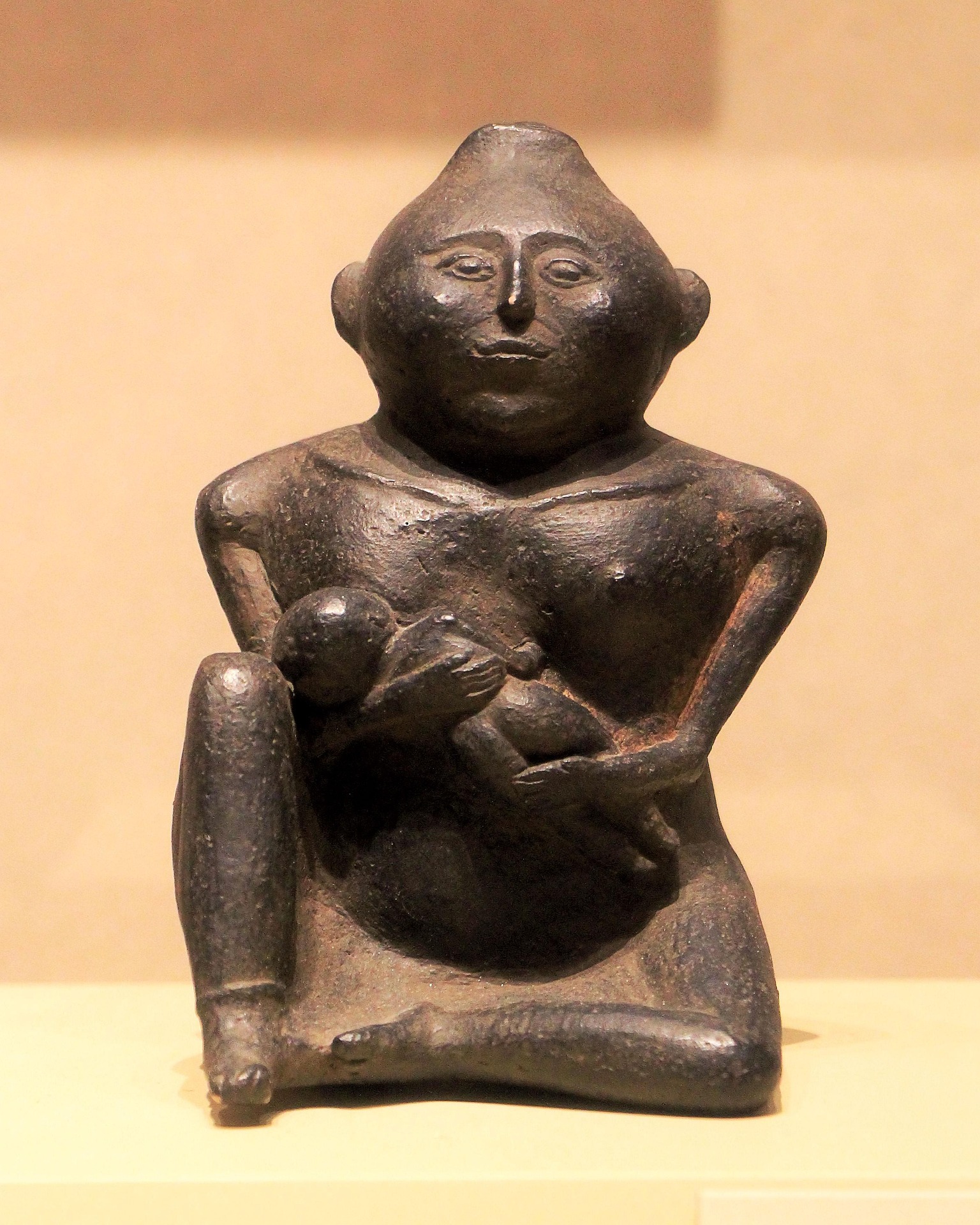 Statue of a seated goddess breastfeeding